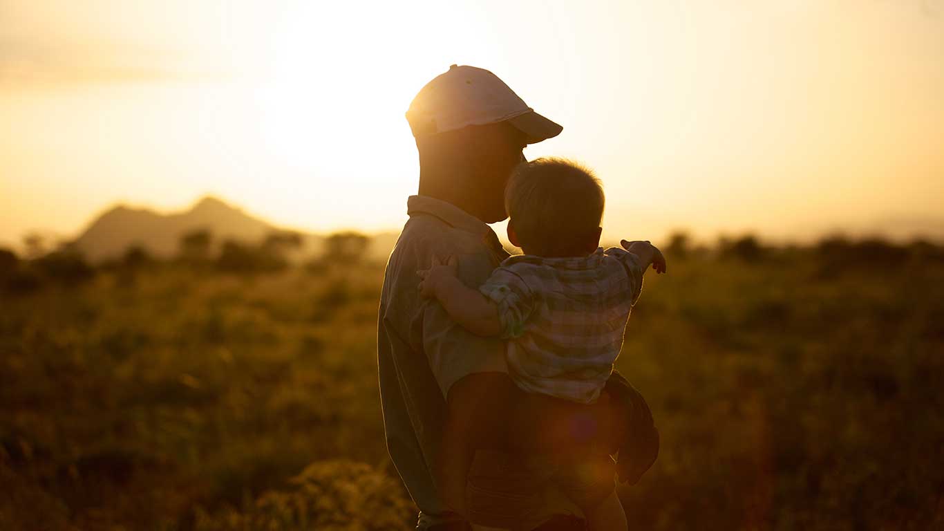 Family Safari - Guide and Child at Sunset